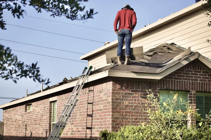 Professional roofer working on a residential roof in East Moline